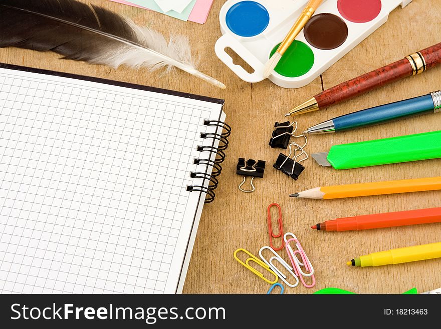 Set of school accessories on wooden background