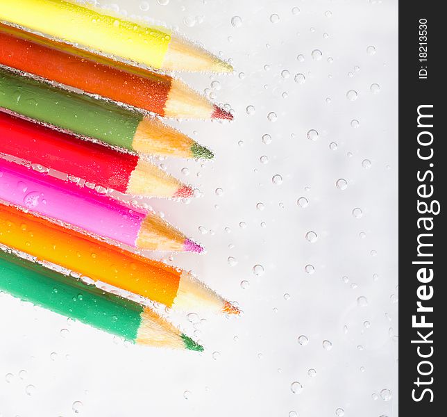 Colorful pencils and bubbles on a white background