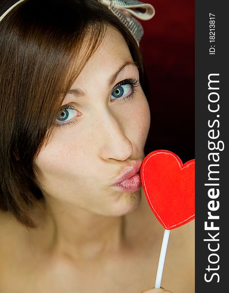 Female portrait with heart candy. Female portrait with heart candy