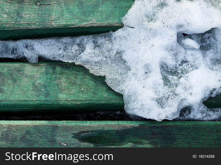 Texture of ice melting on green wood boards. Texture of ice melting on green wood boards.