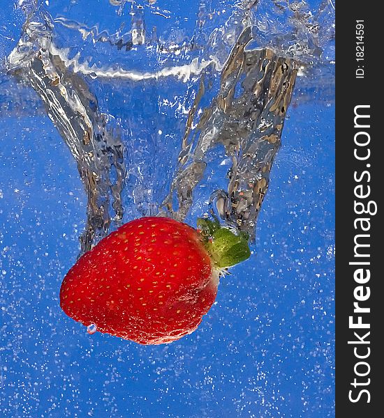 Strawberry splash on blue background