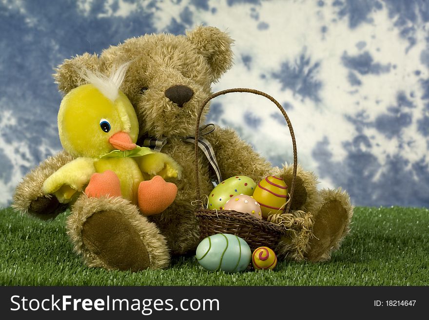 Stuffed animal toys with Easter basket and eggs on green grass. Stuffed animal toys with Easter basket and eggs on green grass