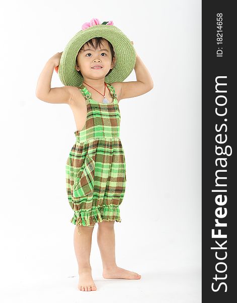 The girl standing with a green hat and wearing green grid clothes. The girl standing with a green hat and wearing green grid clothes.