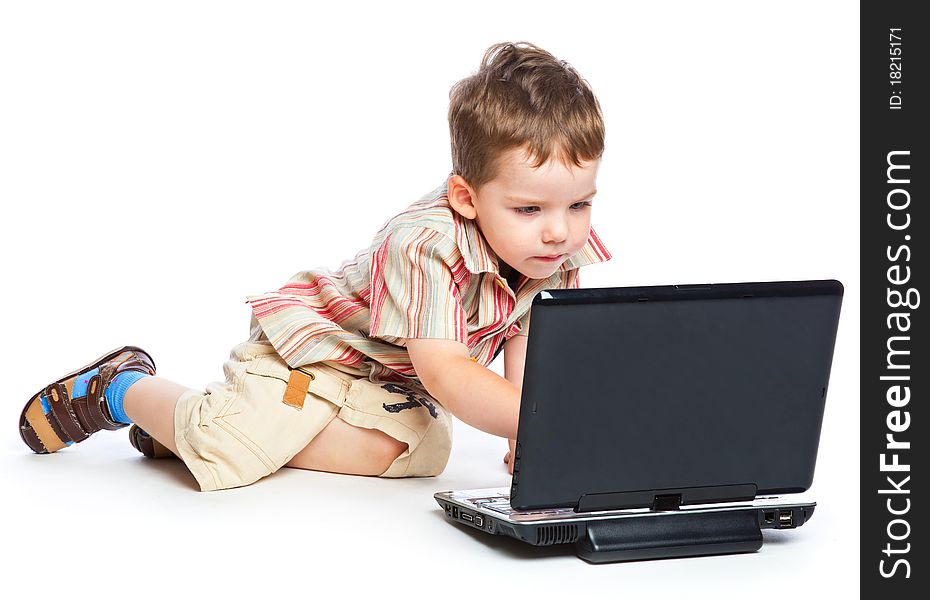 A cute boy is typing on a laptop. isolated on a white background