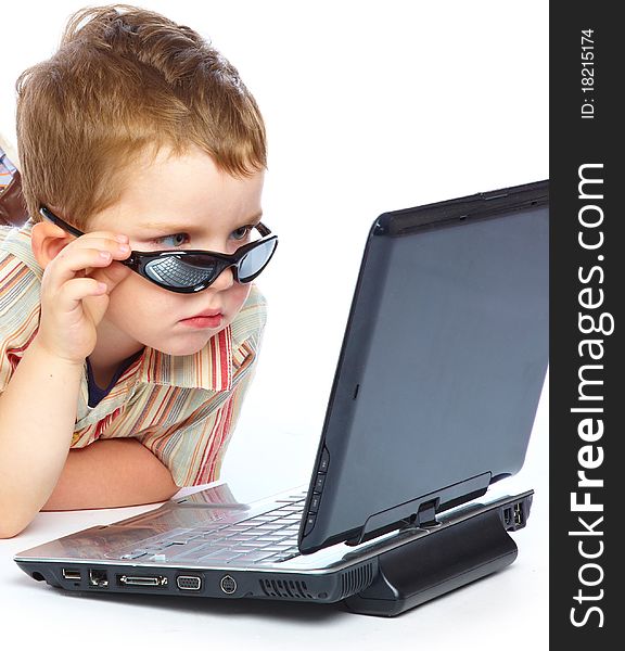 A cute boy is typing on a laptop. isolated on a white background