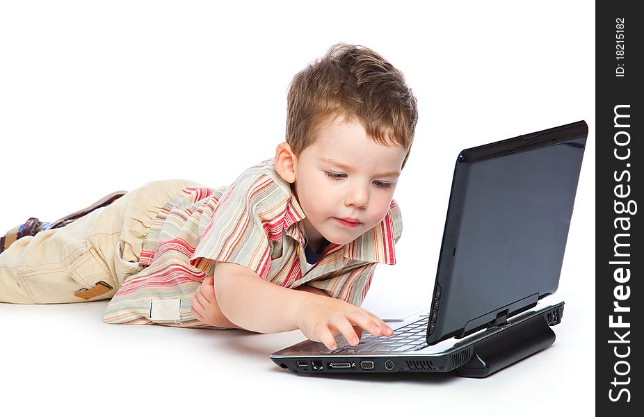 A cute boy is typing on a laptop. isolated on a white background