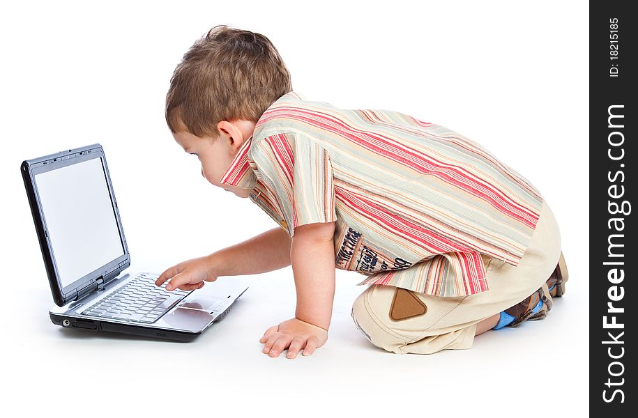 A cute boy is typing on a laptop. isolated on a white background