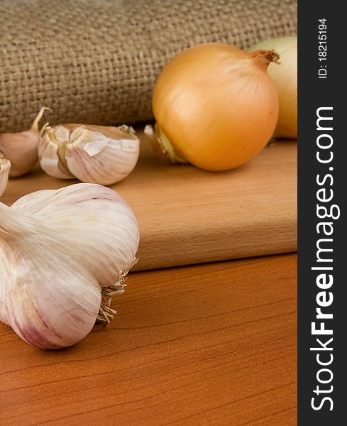 Onion and garlic on sacking background material