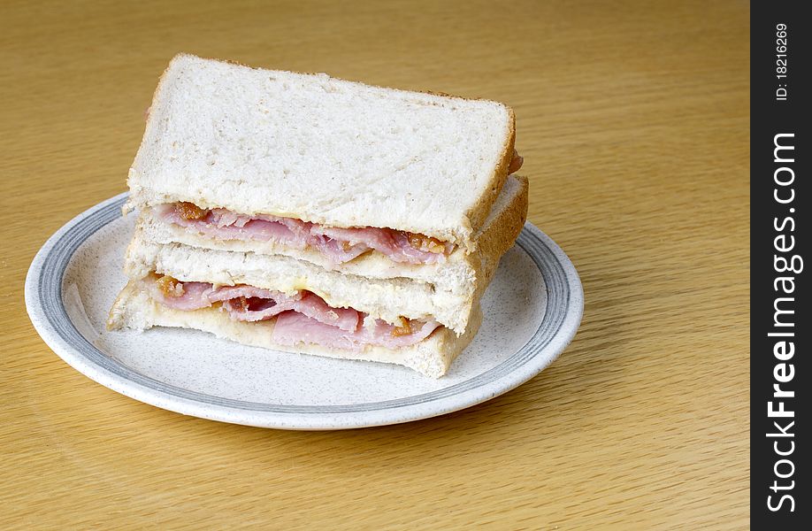 Two bacon sandwiches on a plate