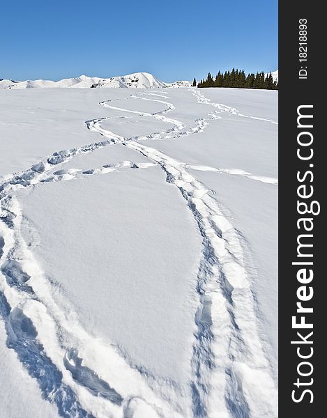 Footprints in the snow on a mountain ridge