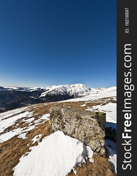 Mountain landscape with rocks in the foreground