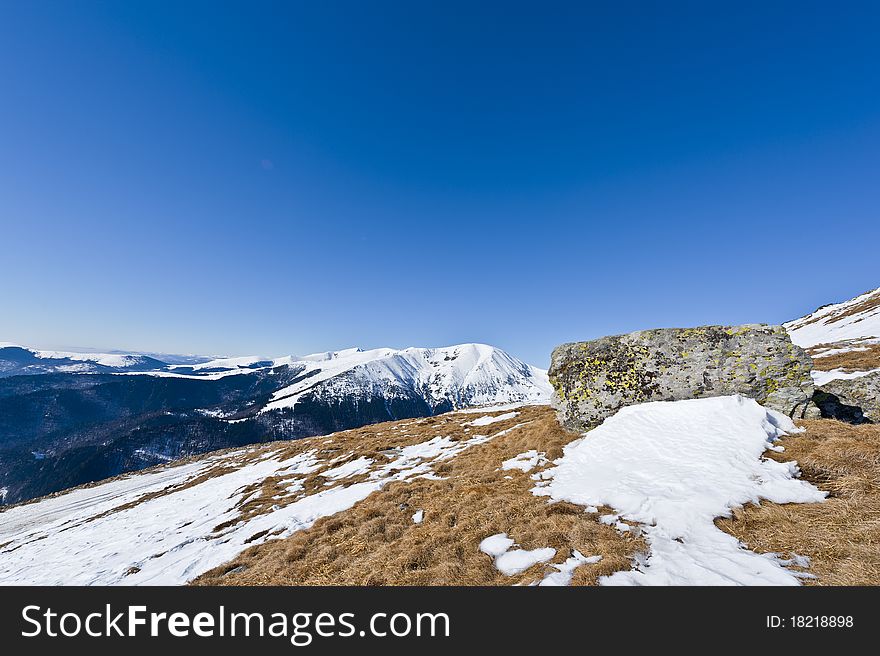 Mountain landscape with rocks in the foreground