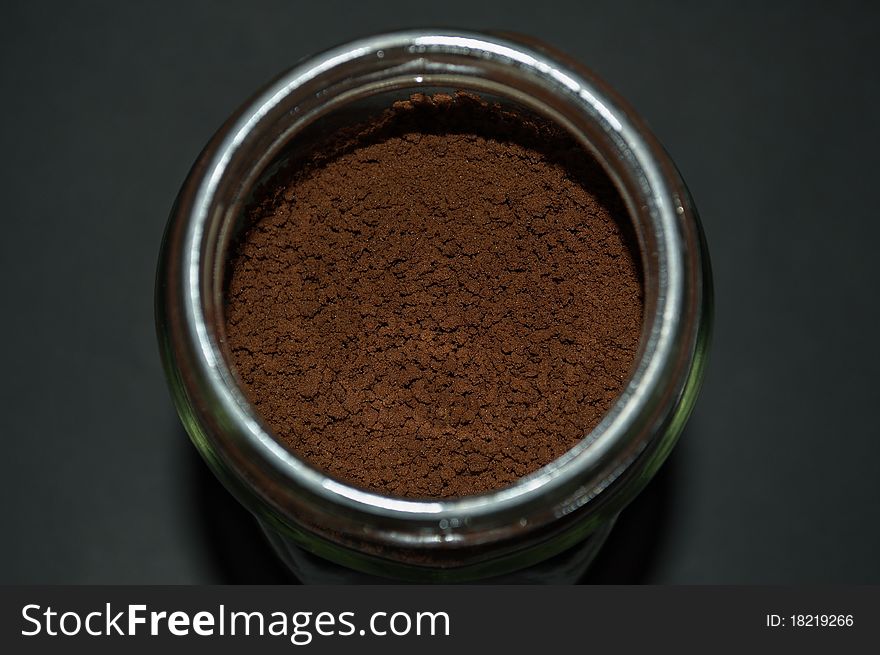 Close up shoot of a soluble coffee glass jar, focusing on the powder to show its texture. Close up shoot of a soluble coffee glass jar, focusing on the powder to show its texture.