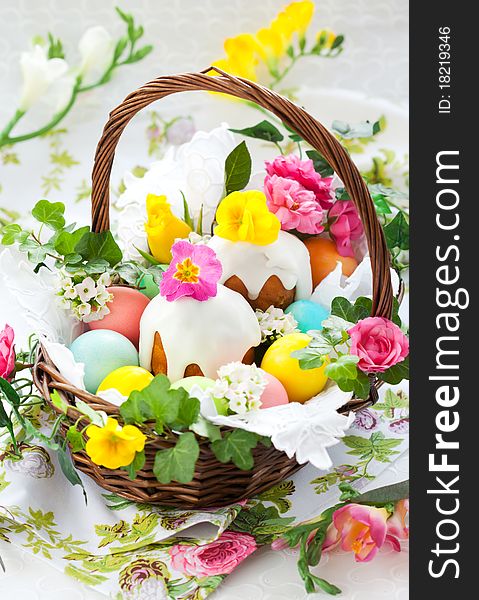 Easter basket with eggs,cake and flowers. Easter basket with eggs,cake and flowers