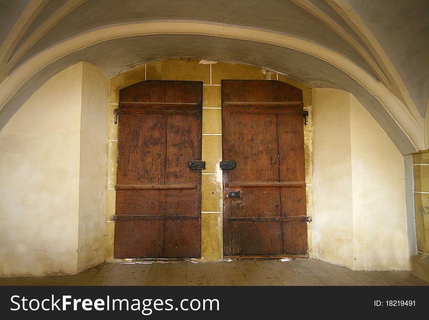 Old dark double door. Medieval church entrance.