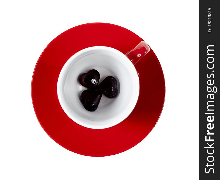 Red cup on the saucer with hearts on white