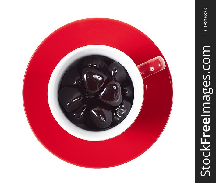 Red cup on the saucer with hearts on white