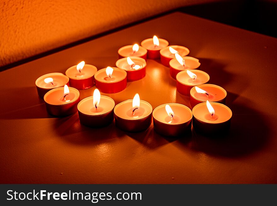 Romantic heart made of candles.