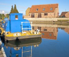 Houses And Boat Next To A River With Reflection Royalty Free Stock Photography