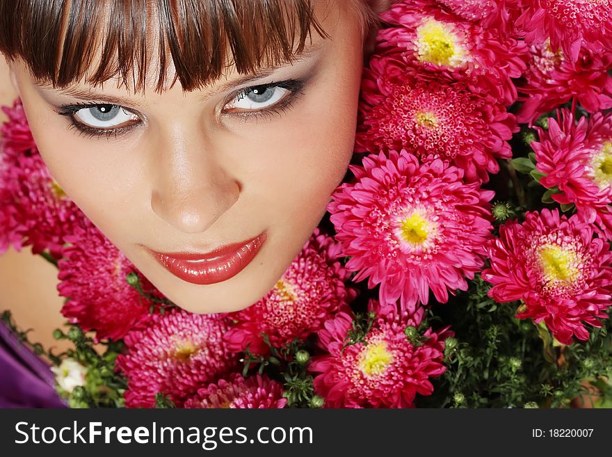 Portrait of a young woman with pink flowers. Portrait of a young woman with pink flowers