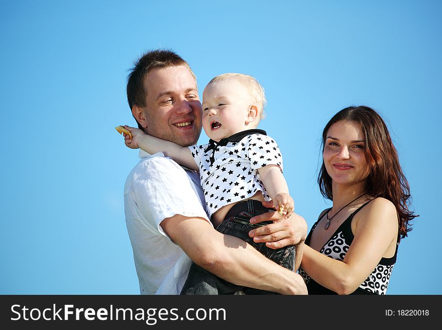 Happy family on blue sky background. Happy family on blue sky background