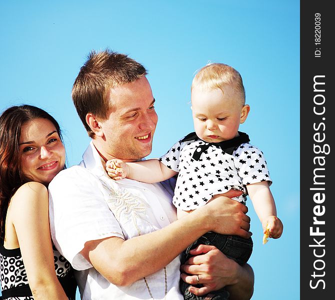 Happy family on blue sky background. Happy family on blue sky background