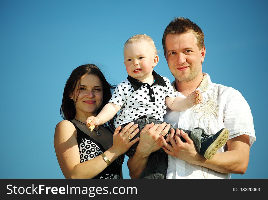 Happy family on blue sky background. Happy family on blue sky background