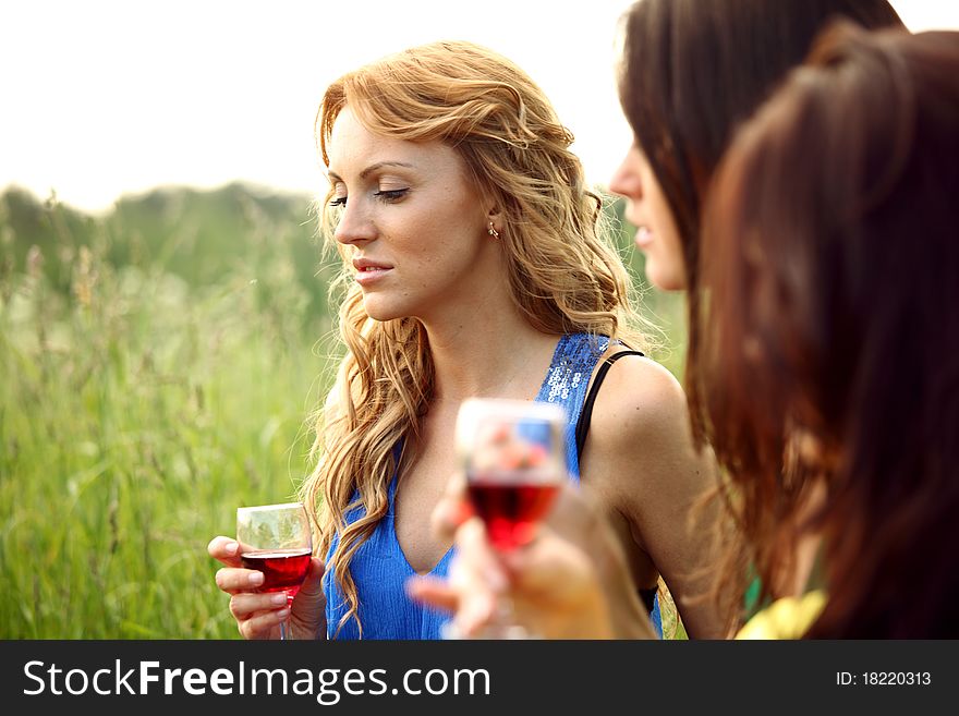 Girls drink wine on nature background. Girls drink wine on nature background