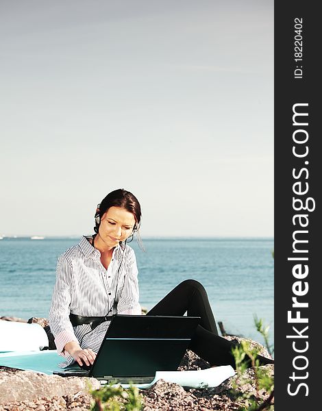 Woman work on laptop sea on background. Woman work on laptop sea on background