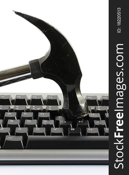 Hammer striking a computer keyboard representing frustration or anger. Hammer striking a computer keyboard representing frustration or anger