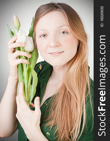 Young girl with tulips, with grey background. Young girl with tulips, with grey background