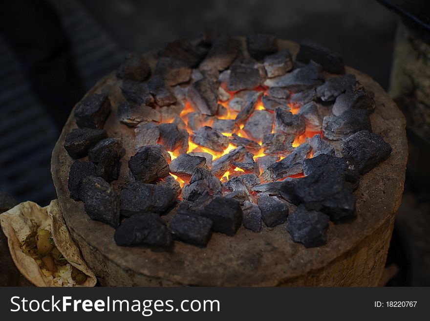 Charcoal stove burning hot with chapati