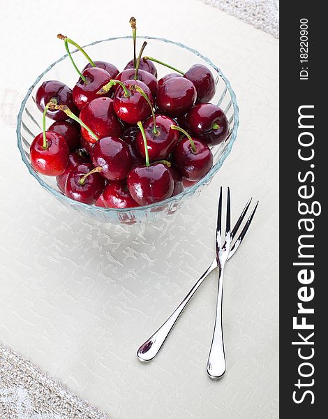 A bowl of fresh cherry with two fruit fork for couple. A bowl of fresh cherry with two fruit fork for couple.