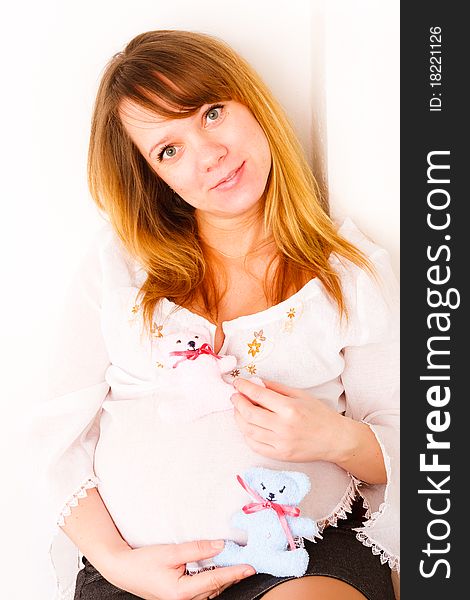 Pregnant woman with soft toys