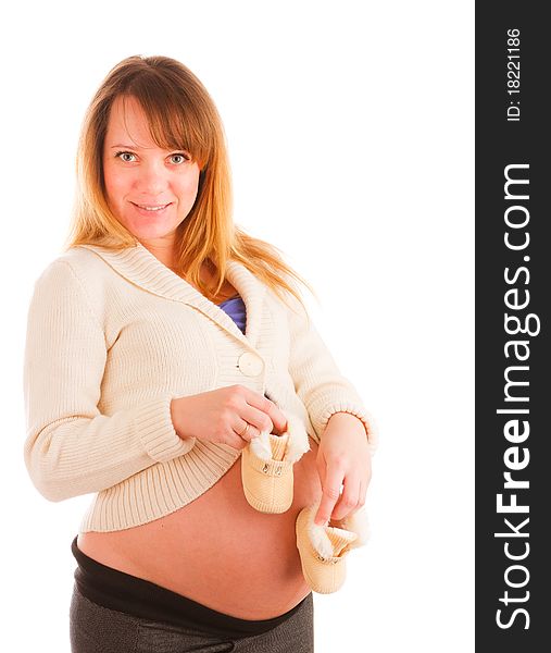 Pregnant woman holding pair of baby's bootee. Pregnant woman holding pair of baby's bootee