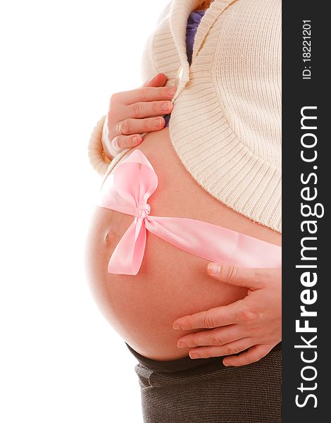 Belly of a pregnant woman with pink ribbon on white background. Belly of a pregnant woman with pink ribbon on white background