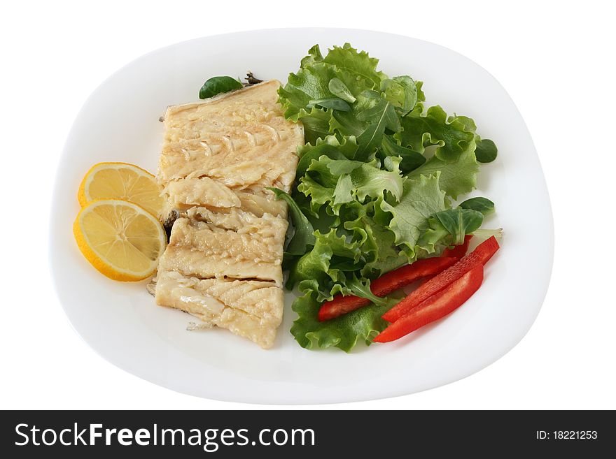 Boiled codfish with salad, pepper and lemon