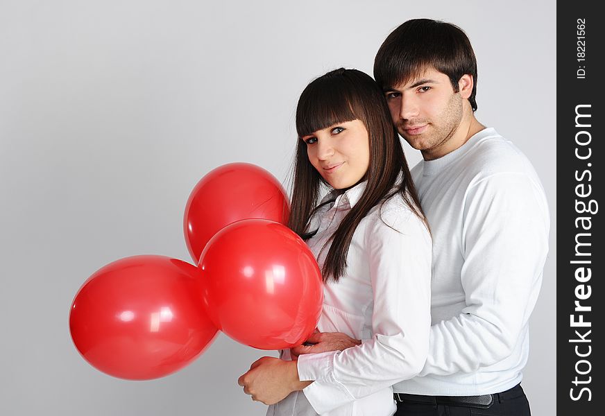 Young love couple with red balloons