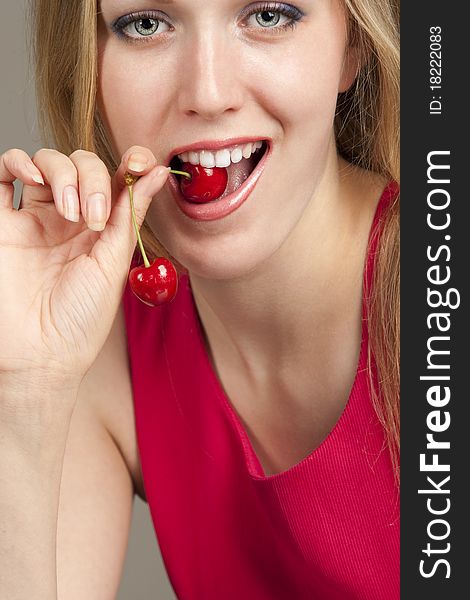 Sexy young woman eating red cherries. Sexy young woman eating red cherries