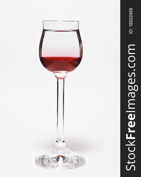 Glass for vodka with drink on white background