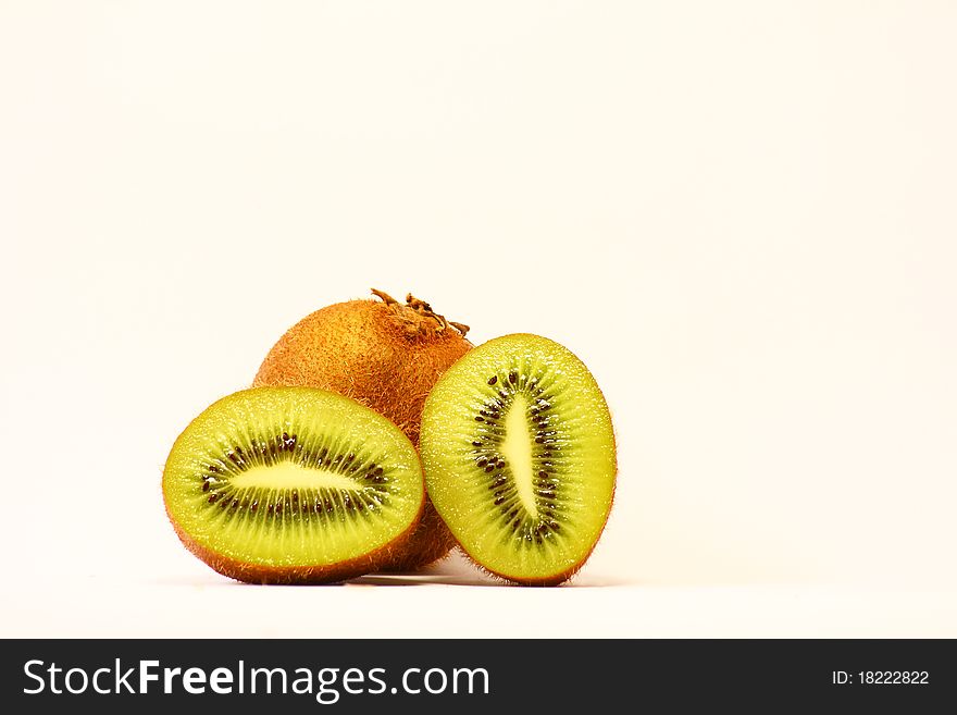 Fresh pieces of kiwi fruit on white background