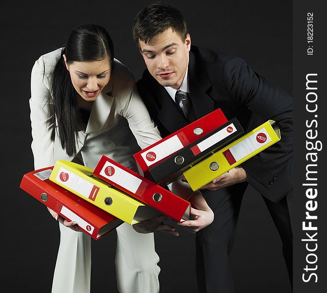 Young businessman and woman holding files. Young businessman and woman holding files