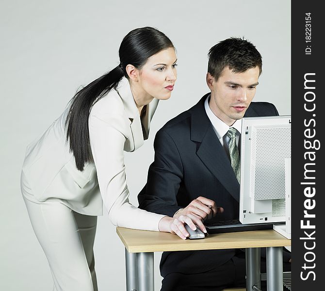 Businesswoman and businessman at computer. Businesswoman and businessman at computer