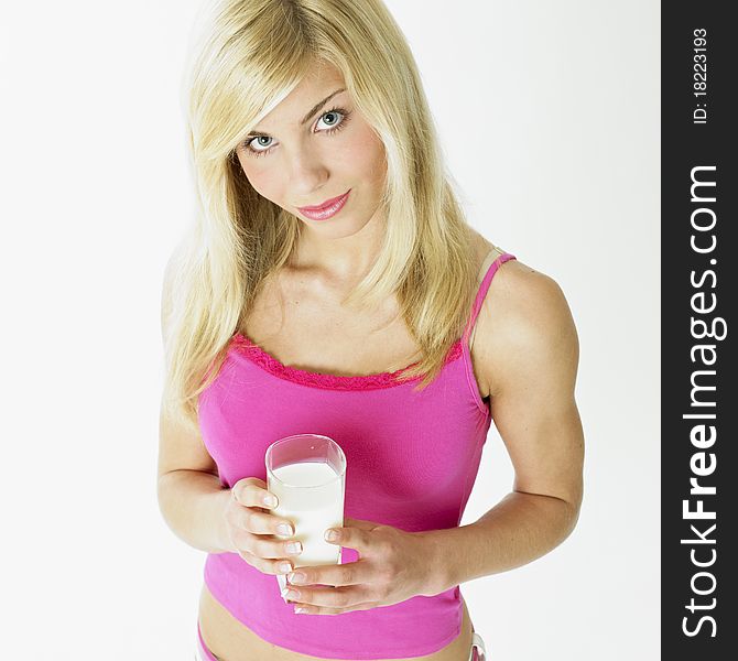 Portrait of young woman with a glass of milk