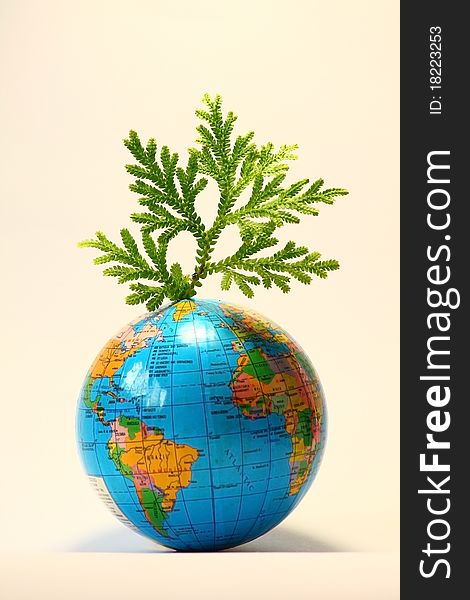 Green leaf on globe on white background. Green leaf on globe on white background