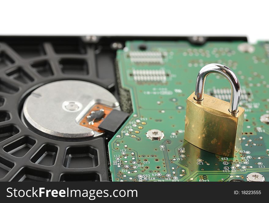 Padlock sitting on computer hard disk drive