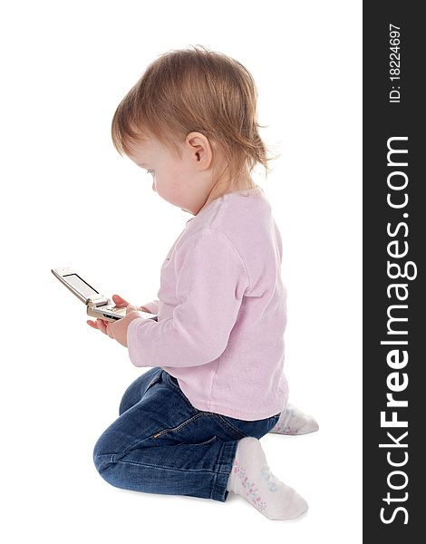 Little girl plays with mobile phone isolated