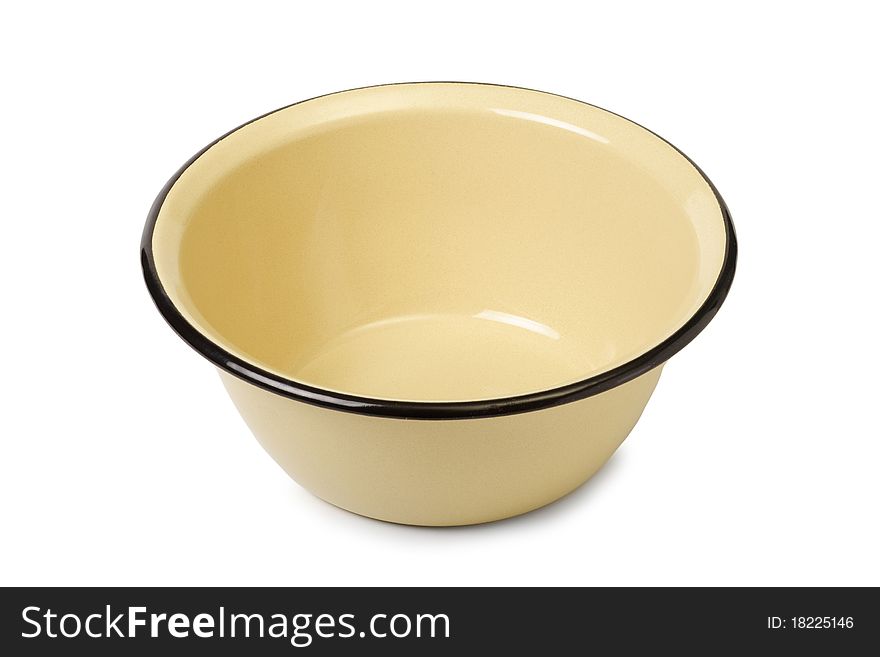 The yellow enameled plate is isolated on a white background. The yellow enameled plate is isolated on a white background