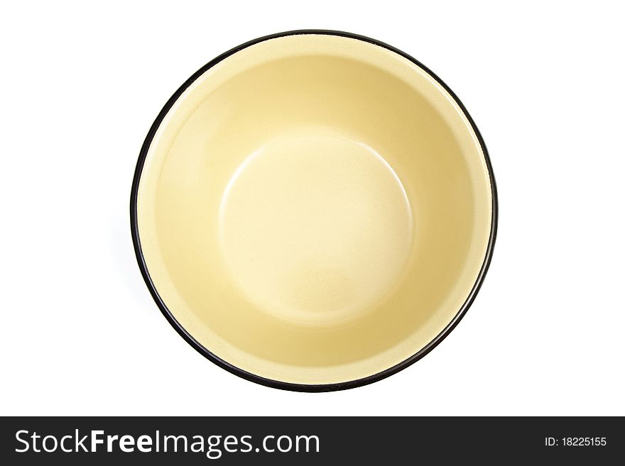The yellow enameled plate is isolated on a white background. The yellow enameled plate is isolated on a white background