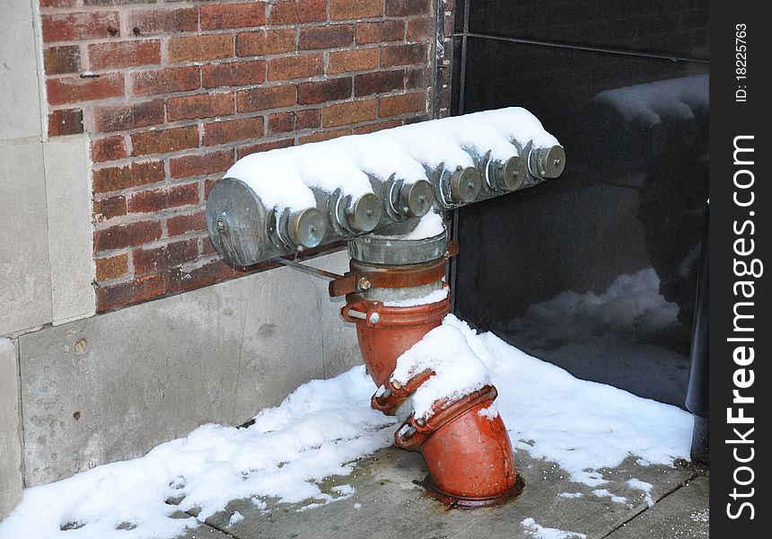 Fire hydrant with multiple outlets covered in snow. Fire hydrant with multiple outlets covered in snow